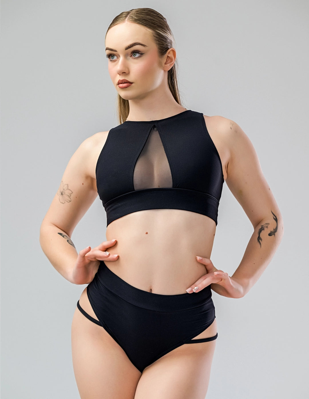 Model wearing Pole Shorts with Side Straps and a matching crop top, showcasing a stylish and confident pole dancing outfit.