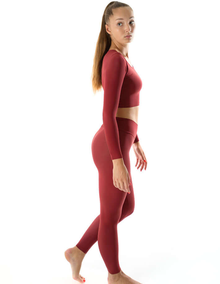 Mid rise leggings in vibrant red, full-length yoga leggings model in profile, showing soft, stretchy comfort.