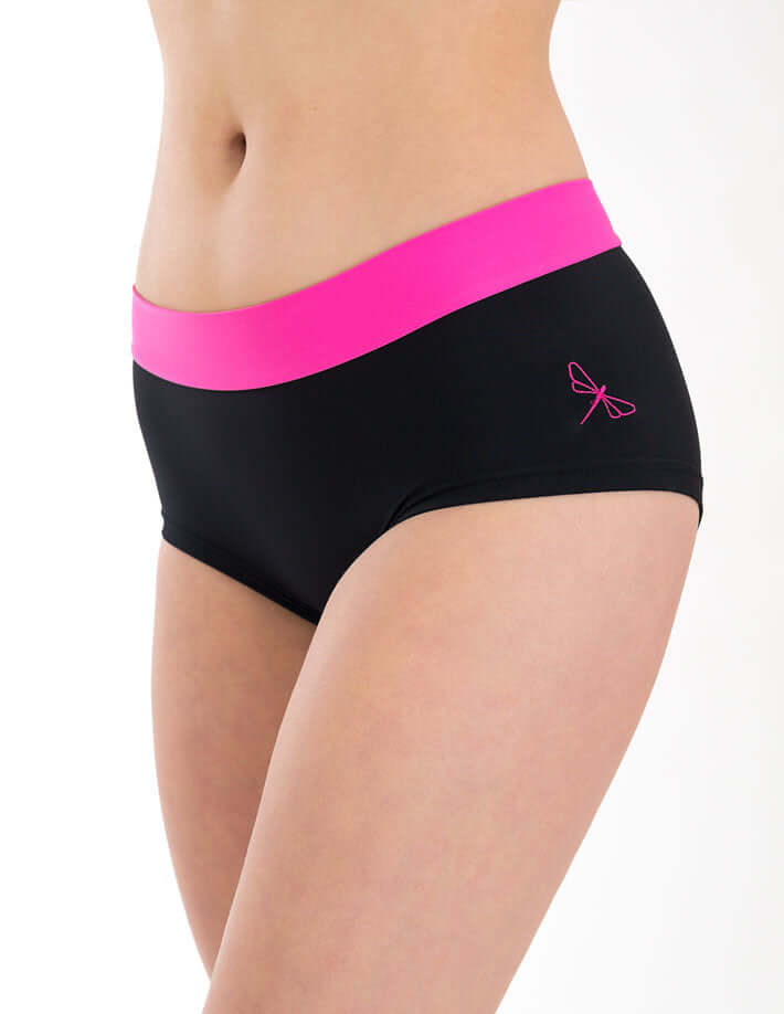 Model wearing mid rise pole dance shorts in black with a pink waistband.